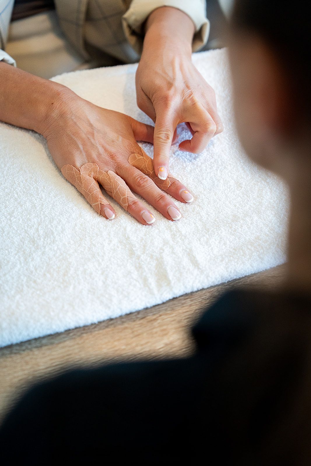 Compression taping applied to a patient's fingertips